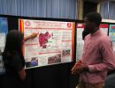 Alexis Cooper explains her summer research to Kevin Oshiokpekhai