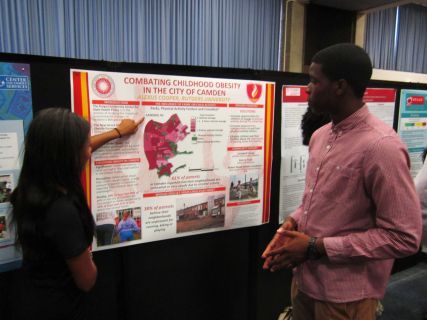 Alexis Cooper explains her summer research to Kevin Oshiokpekhai