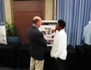 Guest Speaker, Vice President Jorge Reina Schement listens to Dana Bowen speak about her summer research.