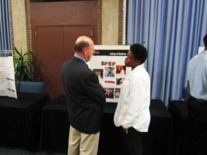 Guest Speaker, Vice President Jorge Reina Schement listens to Dana Bowen speak about her summer research.
